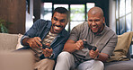Living room, friends and gaming with controller on sofa for multiplayer, competition and entertainment. Happy, people and men with smile in home for esports challenge, streaming and playful contest
