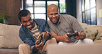 Living room, men and gaming with controller on sofa for multiplayer, competition and entertainment. Happy, people and friends with smile in home for esports challenge, streaming and playful contest