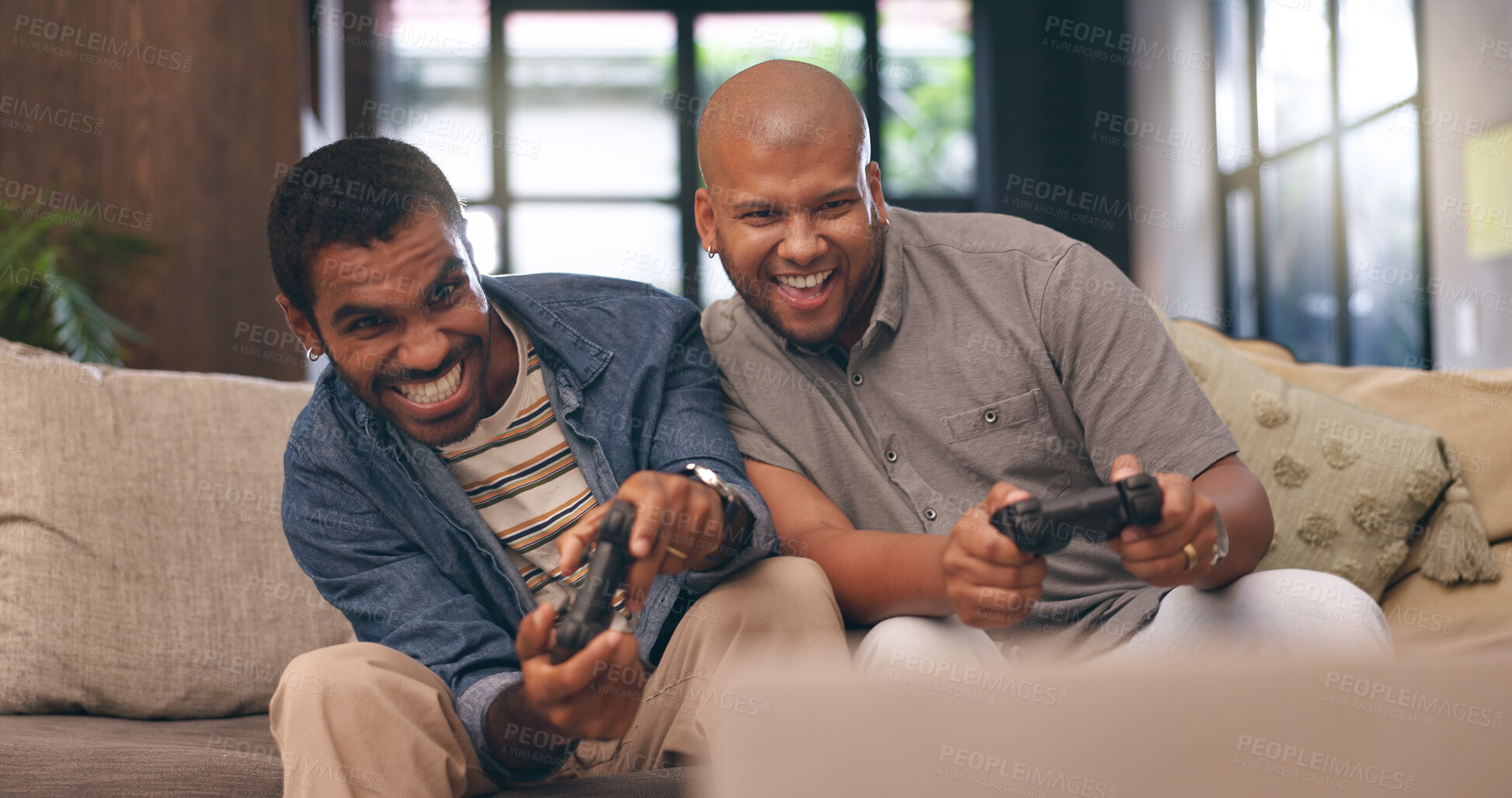 Buy stock photo Living room, men and gaming with controller on sofa for multiplayer, competition and entertainment. Happy, people and friends with smile in home for esports challenge, streaming and playful contest