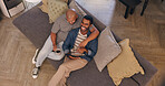 Coffee, laughing and tablet with gay couple on sofa in living room of home together from above. Break, funny and hug with happy lgbt men in apartment for browsing, comedy or romance on weekend