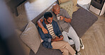 Coffee, hug and phone with gay couple on sofa in living room of home together from above. App, break and social media with happy lgbt men embracing in apartment for browsing or romance on weekend