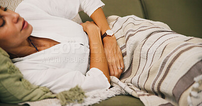 Buy stock photo Sick, cramps or woman with stomach pain on sofa for illness, tummy ache or menstruation. Period, endometriosis or female person with sore abdomen with PMS, menstrual discomfort or indigestion in home