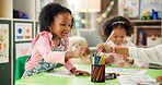 Creative, kindergarten and drawing with girl in classroom for child development, artwork and color project. Friends, academy and growth with students at school for knowledge, learning and education