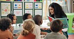 Reading, students and teacher with children in classroom for education, books and creative. Growth, kindergarten and academy with woman and kids at school for youth, knowledge and child development
