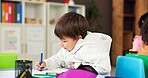 Color, education and drawing with boy in classroom for child development, artwork and creative project. Youth, academy and growth with students at school for knowledge, learning and kindergarten