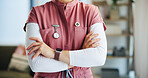 Arms crossed, homecare and medical with nurse in living room for insurance, trust or visit. Confident, healthcare and wellness with medicine professional in apartment for appointment or checkup