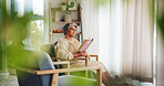 Senior, woman and reading a book in home for knowledge, cognition and retirement hobby on sofa. Elderly person, relax and fantasy novel in lounge for literature, weekend break and story concentration