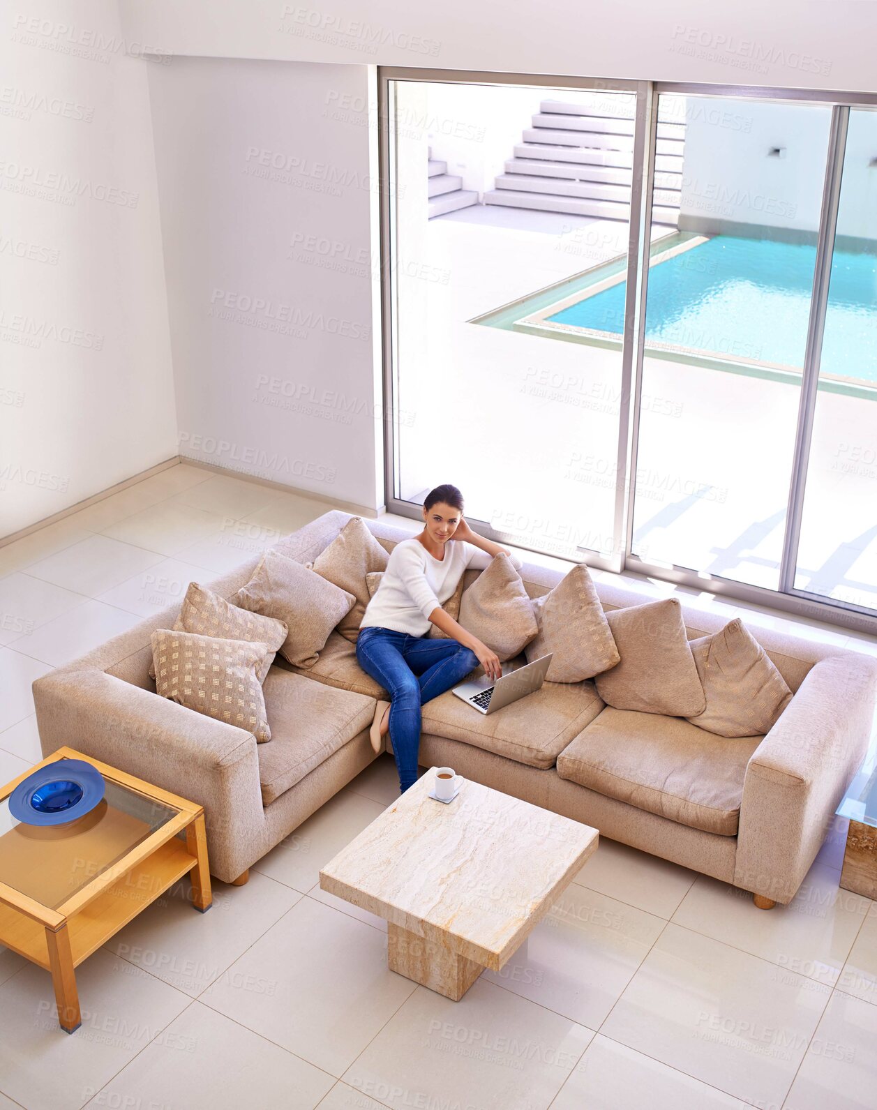 Buy stock photo Living room, relax and woman on sofa with laptop for remote work, internet or website subscription. Computer, online streaming and freelance girl in luxury home checking social media with high angle