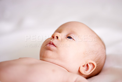 Buy stock photo Cute, baby and relax with curiosity on bed for comfortable, development and resting at home. Calm, sweet and little infant with peace on linen for childhood, wellness and healthy growth in nursery