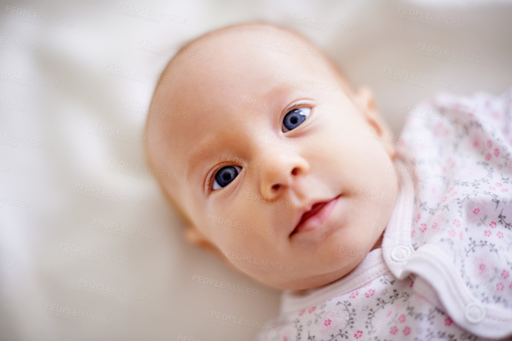 Buy stock photo Above, portrait and baby on bed for rest, relaxing and calm for nap with blanket in nursery. Family, morning and face of newborn in bedroom for child development, comfortable and wellness in home