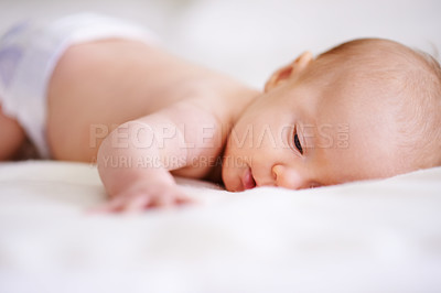 Buy stock photo Baby, bed and infant resting in home, newborn and comfortable lying in bedroom for care. Bare chest, calm and tummy time or healthy skin benefits, peaceful and duvet for childcare in apartment