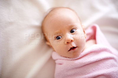 Buy stock photo Calm, baby and curiosity with towel on bed for healthy growth, childhood development and morning bath. Top view, cute and little infant with peace on linen for wrap, wellness and comfortable at home