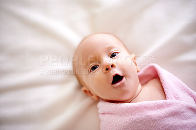 Buy stock photo Blanket, wrap and baby with yawn in portrait for childhood development, rest or healthy growth. Sweet, infant and top view of face with peace on sheet in nursery for comfort, cute or adorable at home