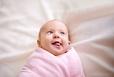Buy stock photo Blanket, playful and baby with tongue out on bed for child development, fun or healthy growth. Cute, infant and top view with peace on sheet in nursery for comfortable, relaxation or adorable at home