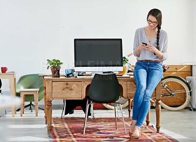 Buy stock photo Woman, office and smile with texting on smartphone for research, online trends and ideas for magazine shoot. Employee, female person and happy for creative business, internet and social media