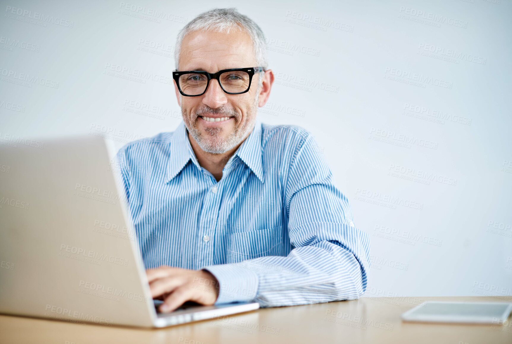Buy stock photo Happy, business and man with laptop in office for research, information and writing report for project review. Mature, male person and portrait editor with digital, website and email for networking