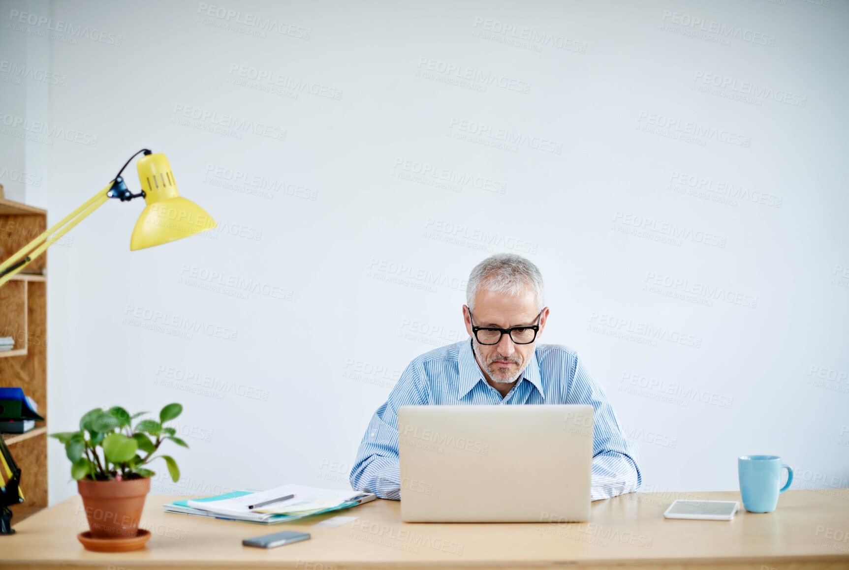 Buy stock photo Serious, business and man with laptop in office for research, information and writing document for project review. Confident, male person and editor with digital, website and email for networking