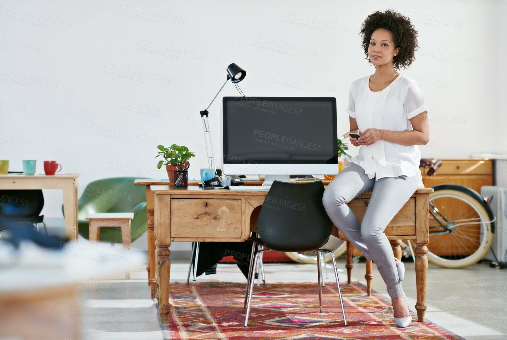 Buy stock photo Woman, office and confident in desk with smartphone for talent research and online trends as casting agent. Employee, female person and serious with small business, model recruitment and photography