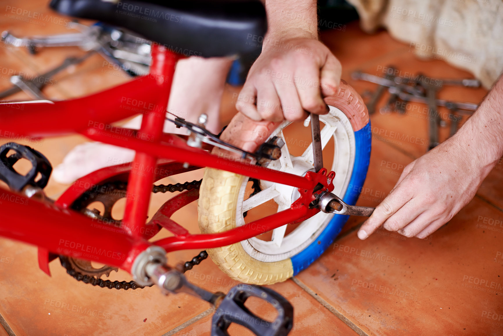 Buy stock photo Repair, kids bike and hands of man in workshop for safety, inspection and checking wheel with spanner. Maintenance, service and person fixing bicycle with tools, care and toys for child development