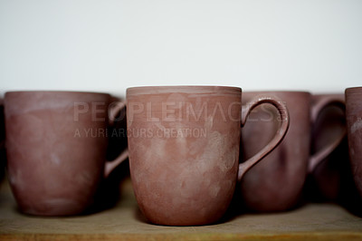 Buy stock photo Pottery, ceramic and cups on shelf in studio for creative design, diy hobby and handicraft. Background, artwork and collection of mugs with space for decoration, texture and aesthetic in kitchen