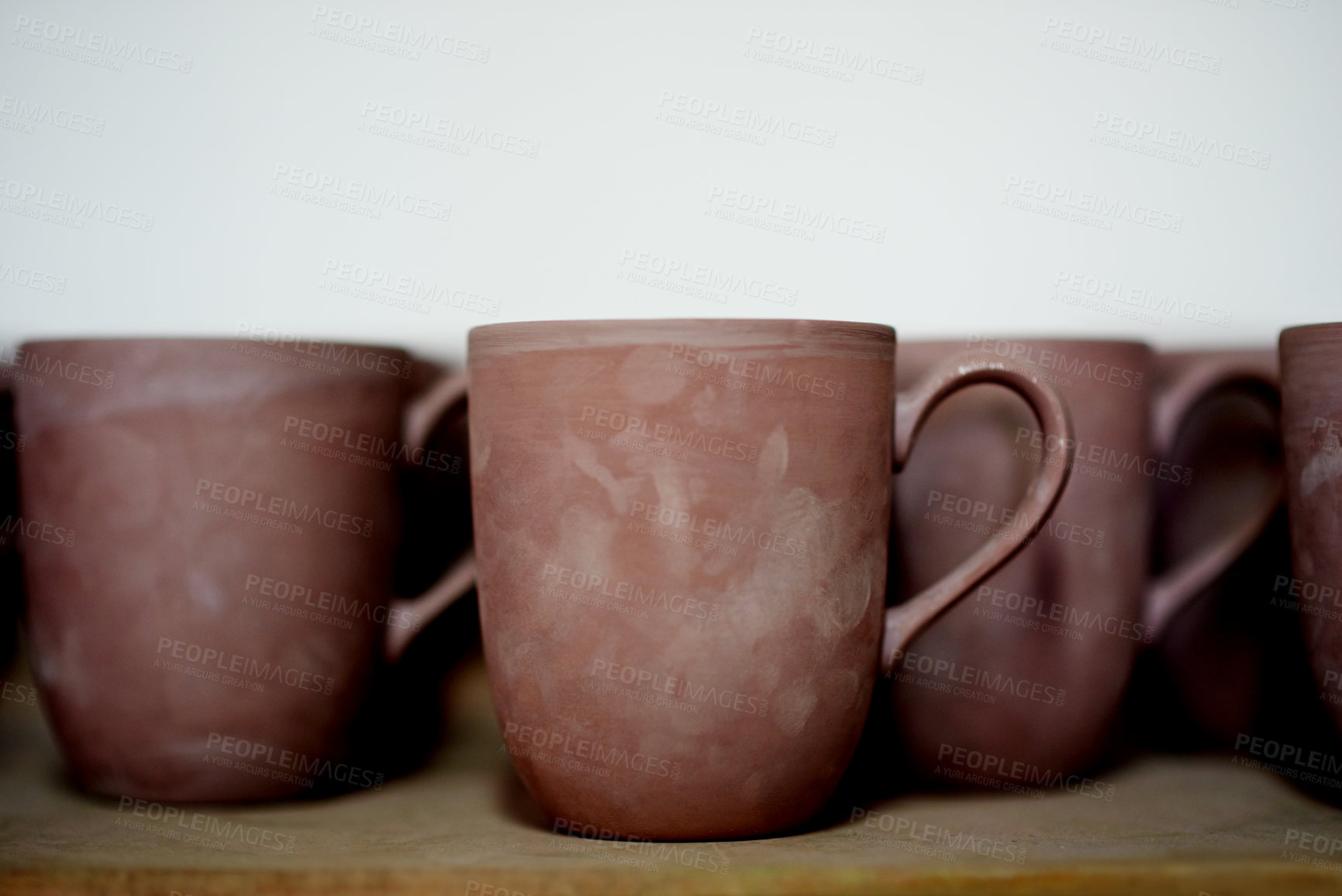 Buy stock photo Pottery, ceramic and cups on shelf in studio for creative design, diy hobby and handicraft. Background, artwork and collection of mugs with space for decoration, texture and aesthetic in kitchen