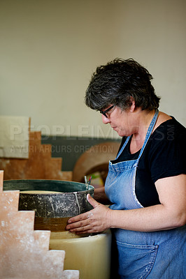 Buy stock photo Woman, pottery and craft at workshop with ceramic manufacturing, profile and sculpture. Person, art and equipment with clay, process and shape with inspection for quality with creativity in studio