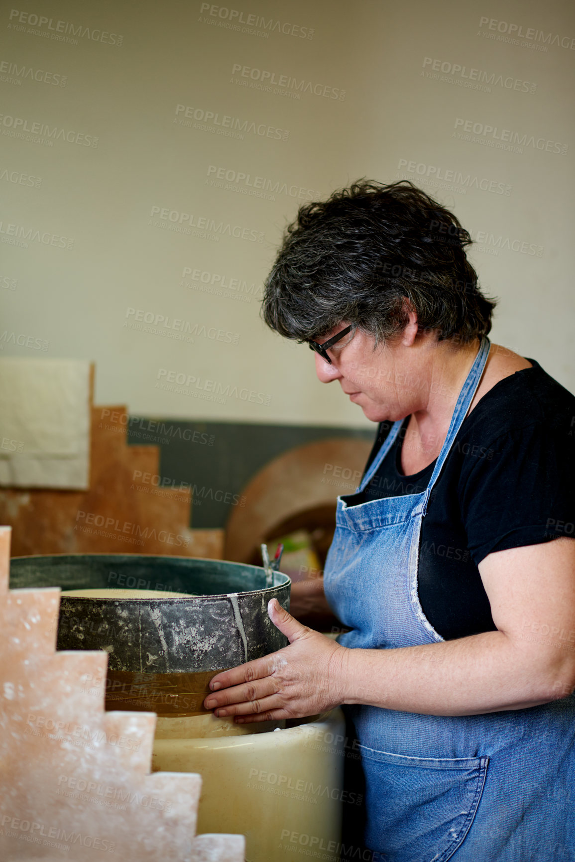 Buy stock photo Woman, pottery and craft at workshop with ceramic manufacturing, profile and sculpture. Person, art and equipment with clay, process and shape with inspection for quality with creativity in studio