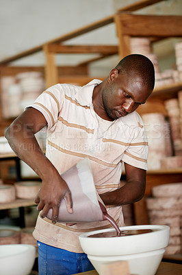 Buy stock photo Pottery, workshop and black man with paint for creative, art or hobby with sculpture manufacturing. Craft, small business and African ceramist with talent, skill or pattern for ceramic product color.