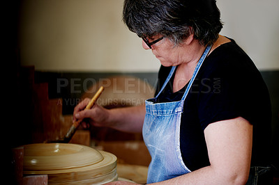 Buy stock photo Pottery, small business and woman in ceramic workshop, clay and creativity with startup. Mature person, entrepreneur or artist in studio, equipment and design material with sculpture or manufacturing