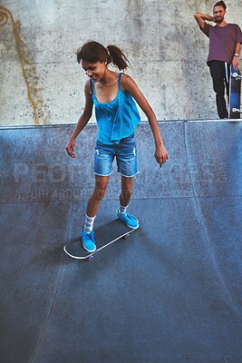 Buy stock photo Skateboard, city and girl on ramp for skating stunt, practice and energy in New York in skate park. Woman, skater and person with smile on concrete for outdoor talent, skill competition and hobby