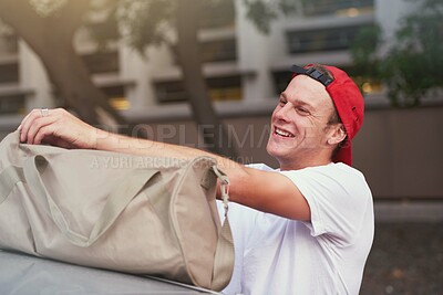 Buy stock photo Smile, man and open bag outdoor with gear, equipment or search kit for travel items on vacation. Holiday, person and luggage in city for trip, unpacking and storage accessory for journey or commute