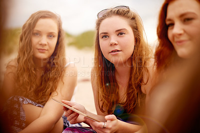 Buy stock photo Summer, friends and women at beach with tablet for relaxing on holiday, vacation and weekend. Travel, outdoor and girl group with digital tech for social media for gathering, picnic and chill