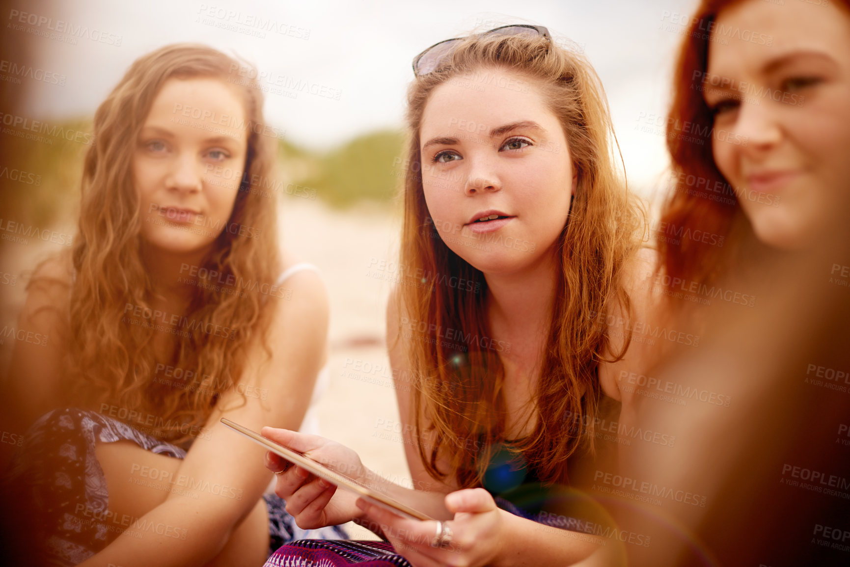 Buy stock photo Summer, friends and women at beach with tablet for relaxing on holiday, vacation and weekend. Travel, outdoor and girl group with digital tech for social media for gathering, picnic and chill