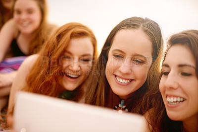 Buy stock photo Girls, tablet and teen friends outdoor together for bonding on holiday, travel or vacation. App, relax and social media with happy people on beach in summer for browsing, streaming or watching
