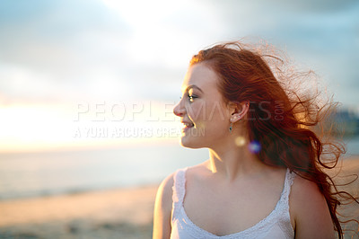 Buy stock photo Smile, sunset and thinking with woman on beach in summer for holiday, travel or vacation. Red hair, sky and wind with happy tourist person outdoor on island coast for ideas, future or wellness