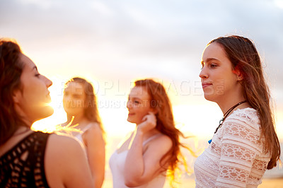 Buy stock photo Beach, sunset and women with vacation, friends and bonding together with social gathering. Ocean, tropical island and people with weekend break, travel and summer holiday with smile, group or seaside