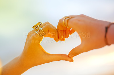 Buy stock photo Sunset, person and outdoor with heart hands for love, travel and freedom at beach environment. Woman, summer and like emoji at ocean with wellness support, vacation or icon for nature care in evening