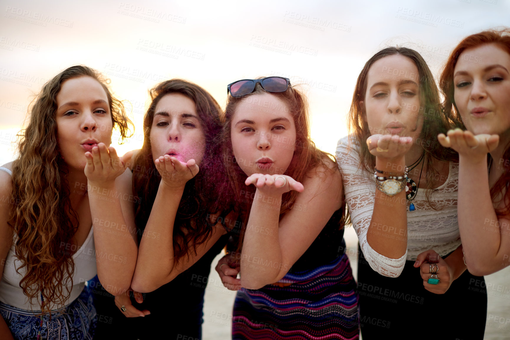 Buy stock photo Girl, friends and blowing glitter outdoor for creative celebration, holiday adventure and bonding. Portrait, people and ethereal kiss with sparkle dust for weekend break, vacation support and fun