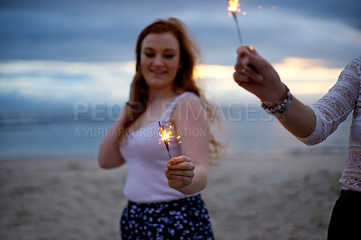 Buy stock photo Sparkler, happy and friends at night at beach for festival, holiday and celebration for party, rave and new years eve. Nature, smile and woman with lights for aesthetic, sparkle and event outdoor