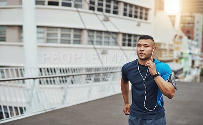 Buy stock photo Man, fitness and earphones outdoor for music, running, and sports training with commitment or energy. Athlete, wellness and cardio in morning for health, workout and performance with sound or audio