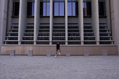 Buy stock photo Skateboard, skill and man in city for outdoor activity, exercise or sports development. Building, fitness and male skater athlete in urban town for hobby, training or workout for gen z culture.