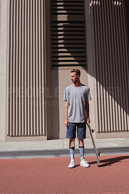 Buy stock photo Skateboard, streetwear and urban with man in city for culture, extreme sports and trick flip. Fitness, hobby and street league with person training downtown for skating, ollie grind and balance 