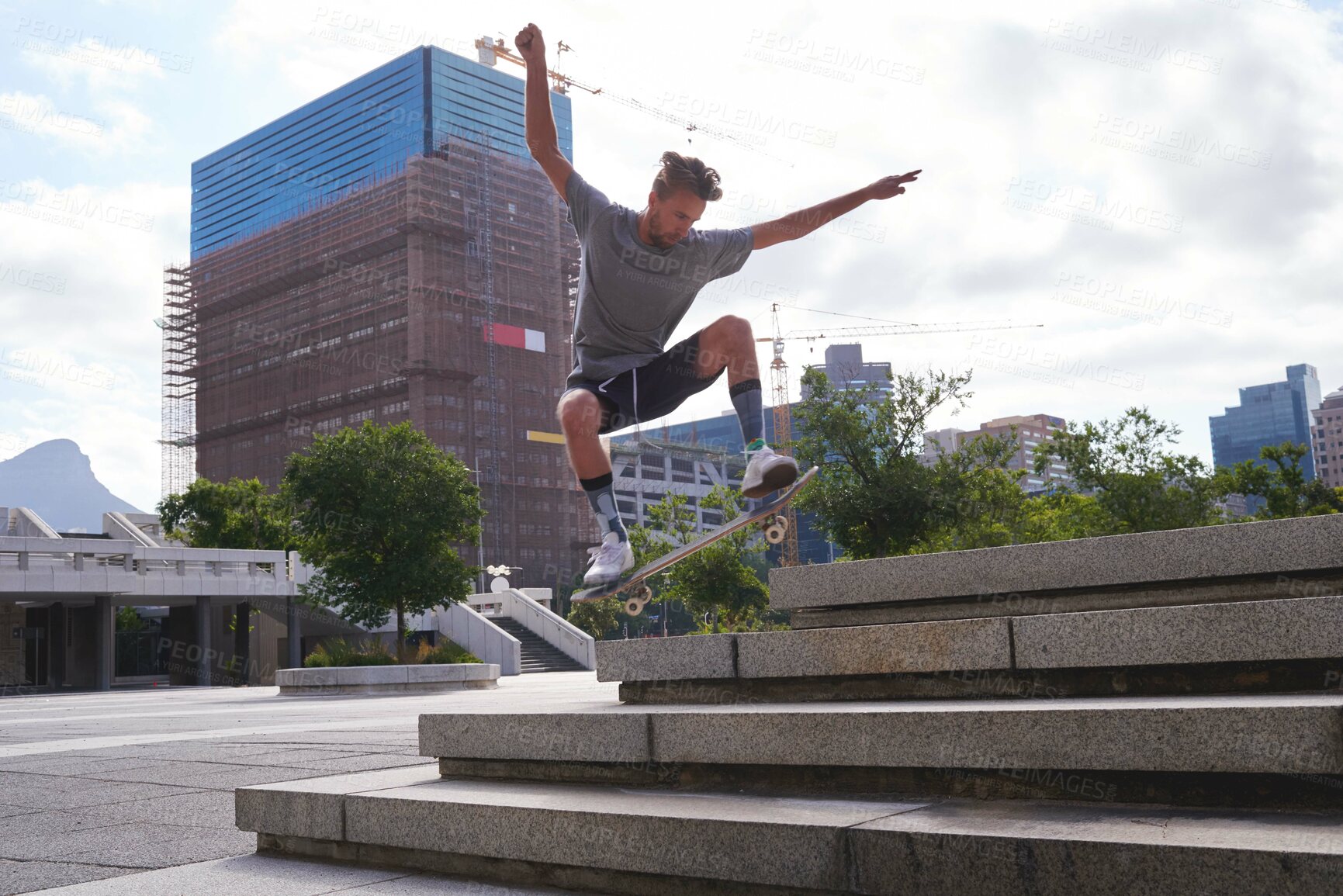 Buy stock photo Skateboard, jump and stairs with man in city for culture, extreme sports and trick flip. Fitness, hobby and street league with person training downtown for skating, ollie grind and balance practice