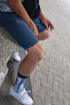 Buy stock photo Man, skateboard and feet in urban city, smoking cigarette and skating break on asphalt. Fitness, outdoor hobby and skateboarder for practice in downtown, athlete relaxing and legs for stunt rest