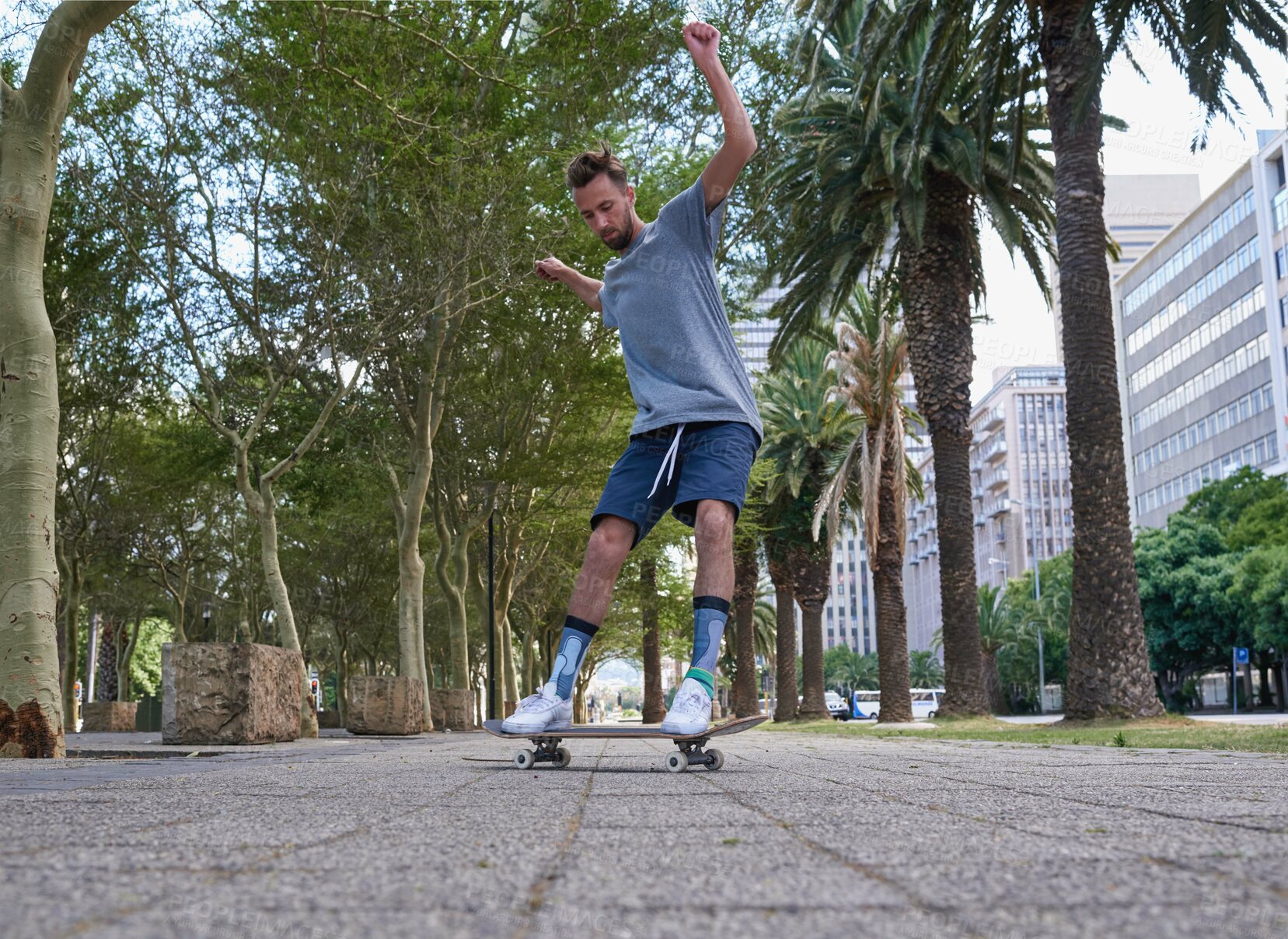 Buy stock photo Skateboard, fitness and urban with man in city for culture, extreme sports and trick flip. Path hobby and street league with person training downtown for skating, ollie grind and balance practice
