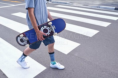 Buy stock photo Legs, man and walking with skateboard in city for sport trip, travel and commute for hobby. Outdoor, skater and hands with person on road for transport, fashion and cool hipster with street.