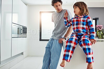 Buy stock photo Dad, boy and kitchen for breakfast in home, discussion and decision on food for eating. Morning, pyjamas and negotiation for sweet brunch, father person and child for bonding and holiday cooking