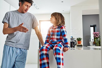 Buy stock photo Father, boy and kitchen for breakfast in home, hungry and decision on food for eating. Morning, pyjamas and negotiation for sweet brunch, dad person and child for bonding and holiday cooking together