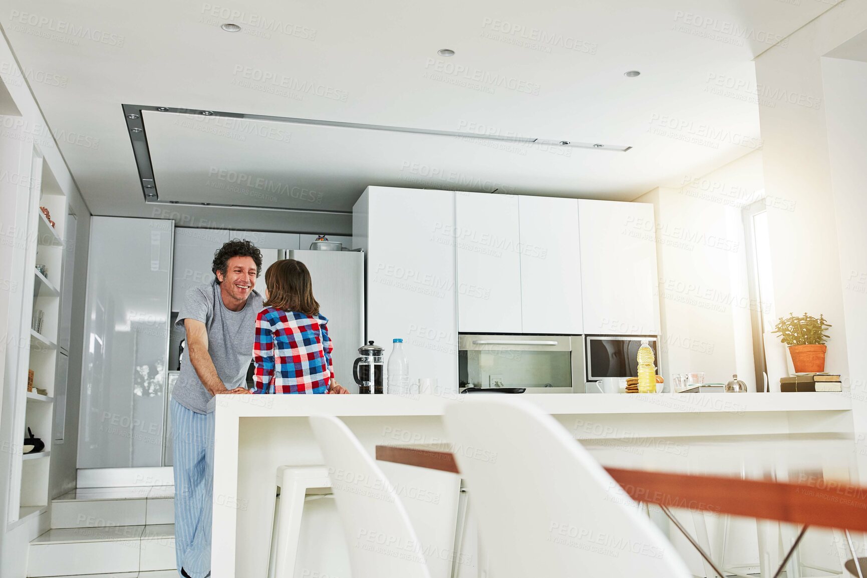 Buy stock photo Dad, boy and kitchen for breakfast with love, home or decision on food for eating. Morning, pajamas or negotiation for sweet brunch, father person or child for bonding and holiday cooking together