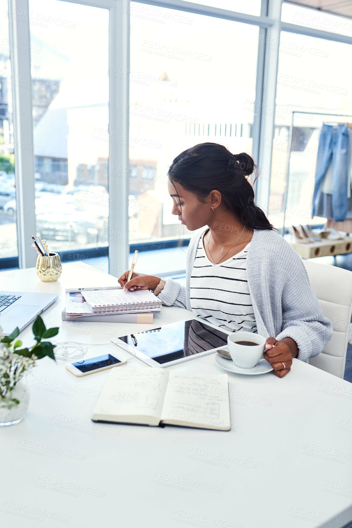 Buy stock photo Girl, laptop and tablet writing in home, study and learning workspace in bedroom for online elearning. Notebook, technology for internet search or social media, coffee and serious student with notes
